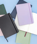 Top Shelf Hardcover Lined Journal Notebook With College Ruled Pages For Your Daily Grind And Heavy Note Taking laid flat with colorful covers