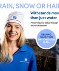 Smiling woman in a blue fleece jacket and white beanie promoting durable protection against rain, snow, and hail.