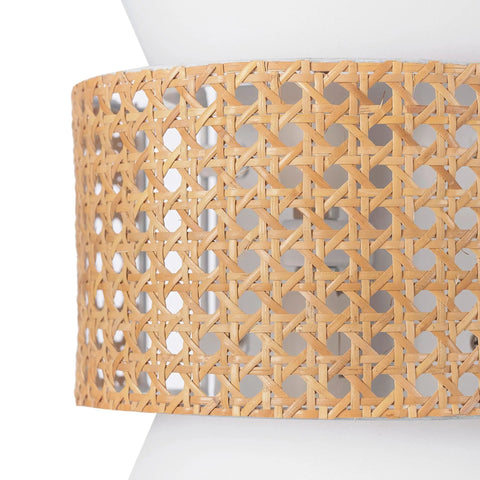 Close-up of natural rattan accent on two-light plug-in or hardwire wall sconce with matte white fabric shade