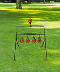 Auto Resetting BB Gun Targets For.177 And.20 Caliber on grassy backyard, sturdy black steel frame with red target stickers