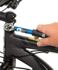 Hand using Ratcheting Torque Wrench With A 2 To 14 Nm Range And 18 To 124 Inch Pounds Readout Three Eighth Inch Drive on bike