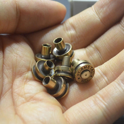 Solid Brass Bullet Rivets With Screw Posts Give Your Leather Accessories A Badass Antique Vibe Perfect For Custom Wallets And Rugged Backpack Repair Projects in hand.