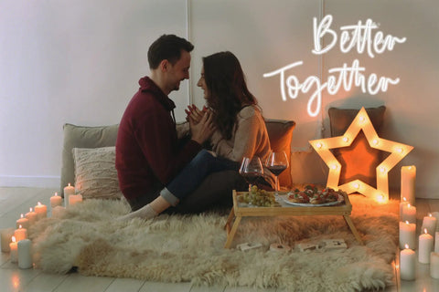 Couple in cozy setting with 'Better Together' neon sign, candles, and star decor, ideal for Pink You Are Like Really Pretty Neon Sign LED Wall Light