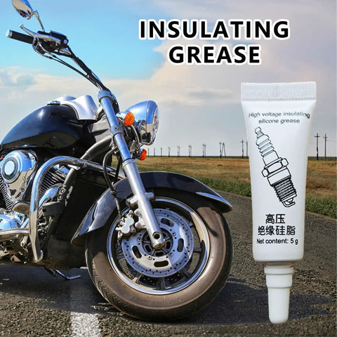 5g tube of high-temp dielectric lubricant for electronics and automotive weatherproof silicone grease next to motorcycle tire