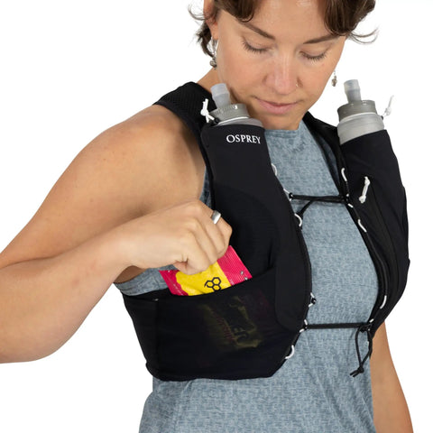 Dyna LT Womens Running Hydration Vest With Hydraulics Soft Flasks in use, showing front pocket storage and flasks, Black Medium