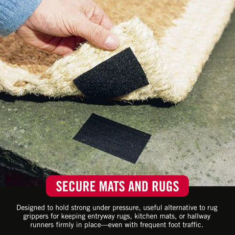 Black adhesive-backed Velcro strip (4x2 in) being pressed onto a rug by hand