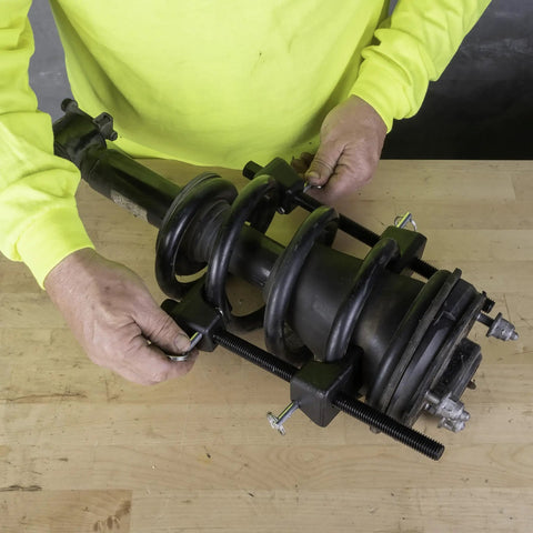 MacPherson Strut Coil Spring Compressor Tool For Safe And Easy Spring Compression in use on strut assembly