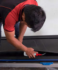 Person applying Treadmill Belt Lube 100 Percent Silicone Oil Made in USA Odorless Safe for Home and Pets Quiet Smooth Run Lubricant