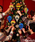 Group decorating Christmas tree with painted Unfinished Wooden Hot Air Balloon Cutouts Set 30 Pack Boxwood Wood Shapes For DIY Crafts