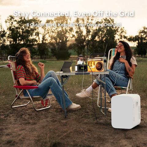 Two people camping using 88.8Wh Portable Solar Generator with 21W Panel for outdoor power on a table.