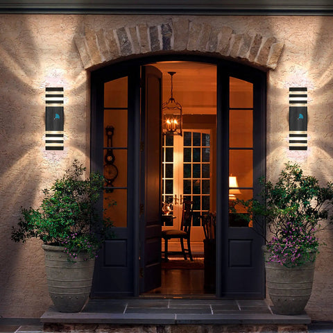 Two Pack Dusk To Dawn Exterior Wall Lights with Auto On Off Sensor, mounted beside a patio door, three-layer aluminum design.