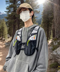 Person wearing Hydration Vest For Outdoor Adventures With Easy Access Water Bladder System Reflective Front Chest Pocket And Multiple Storage Pockets Lightweight Gear Built For Trekking Camping Cycling And Mountaineering on a forest trail.