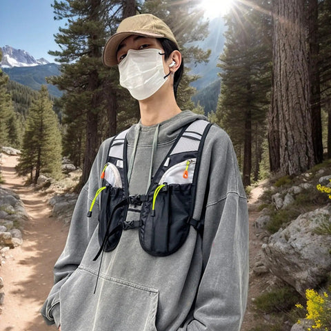 Person wearing Hydration Vest For Outdoor Adventures With Easy Access Water Bladder System Reflective Front Chest Pocket And Multiple Storage Pockets Lightweight Gear Built For Trekking Camping Cycling And Mountaineering on a forest trail.
