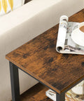 Rustic Brown And Black 3 Tier End Table With Open Storage Shelves holding a cup of coffee and rolled magazine on top surface.