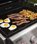 Rust Resistant Outdoor Griddle Insert Full Size Pre Seasoned Carbon Steel Griddle For Searwood And Large Spirit Series Gas Grills Transform Your Grill Into A Flat Top Ready Surface With Even Heat Distribution And Durable Rust Resistant Construction with breakfast cooking on it.