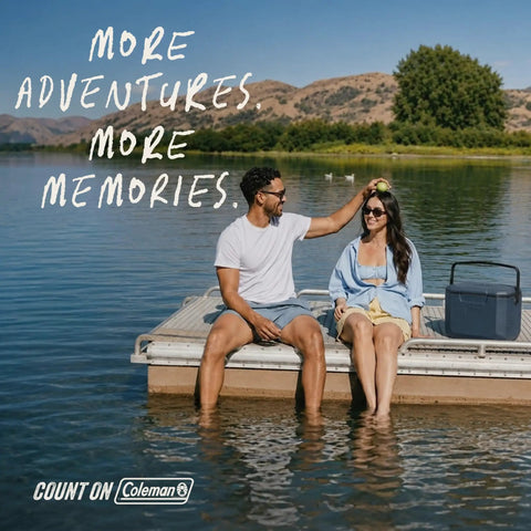 Two people sitting on a dock with a 16 Quart Portable Cooler That Keeps Ice Cold For Up To 36 Hours With TempLock Foam Insulation, Sapphire.