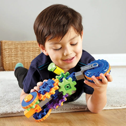 Child playing with Cycle STEM Kit For Hands On Learning And Fine Motor Skills, 30 Piece Toddler Explorer Set with colorful gear bits.