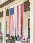 Vintage American Flag Rag Ribbon Banner For Fourth Of July Decor hanging on porch, rustic 4x2.3 ft size, patriotic outdoor display.