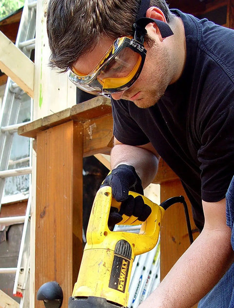Person using power tool wearing Concealer Clear Anti-Fog Dual Mold Safety Goggles With Built-In Ventilation Channel