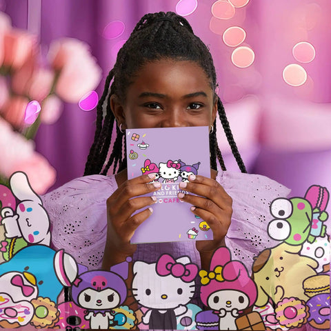 Smiling person holding Hello Kitty And Friends 22-Piece Stationery Set notebook with Sanrio characters.