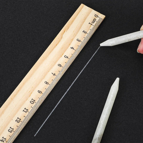 144 Pcs Round Soapstone Pen Refills For Welding And Metal Fabrication shown with ruler on dark surface