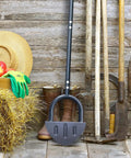 Saw Tooth Lawn Edger With T Grip Handle For Long Reach 38 Inch Half Moon Edging Tool leaning against rustic wall