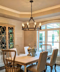 Dining room featuring Black Farmhouse Wagon Wheel Chandelier With 8-Light 23.6 Inch Vintage Industrial Round Pendant Ceiling Light Fixture For Kitchen Island Dining Room Living Room Bedroom Hallway Entryway Foyer With Adjustable Chain hanging above a table.