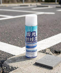 Zerodeko Pavement Striping Paint, Reflective Night Road Visibility Spray next to gray pavement block on asphalt.