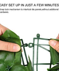 Close-up of hands assembling Artificial Ivy Privacy Fence Screen 118 By 39.4 Inches with snap lock mechanism, faux ivy leaves