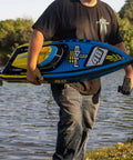Man holding Sonicwake RC Boat 48 Inch Self Righting Brushless 8S Ready To Run With Spektrum Smart Electronics