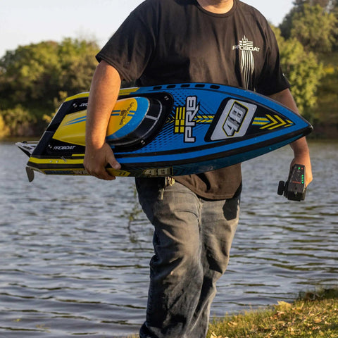 Man holding Sonicwake RC Boat 48 Inch Self Righting Brushless 8S Ready To Run With Spektrum Smart Electronics