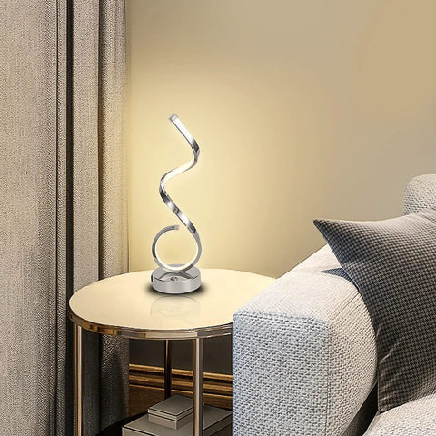 Modern Spiral LED Table Lamp With Dimmable Touch Control And USB Port 22W Reading Light on a side table next to a sofa.