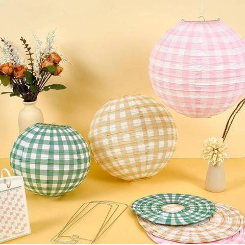 12 Pack Camp Bachelorette Paper Lanterns Set in Gingham Green Tan Pink displayed with floral decor on a table
