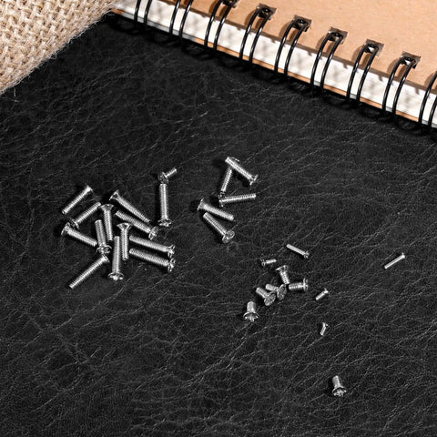 500 Piece Micro Screws Kit With M1.2 M1.4 M2.0 Metric Sizes Hella Tough Carbon Steel Build includes various screws on textured surface.