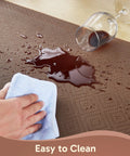 Anti Fatigue Kitchen Floor Mat 20 By 32 Inches Three Quarter Inch Thick Cushioned Ergonomic Standing Pad Waterproof Surface Non Slip Bottom For Home Office Sink Brown with a spill resistant surface being wiped clean.