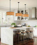 Hoffman 4 Light Matte Black Pendant With Faux Wood Veneer Drum Shade Durable Steel Construction Perfect For Rustic Farmhouse Cabin Lodge Vibe And Transitional Living Spaces in a modern kitchen setting.
