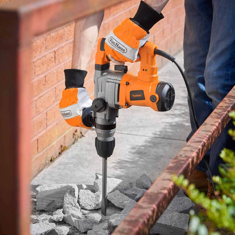 Worker using 10 Amp Rotary Hammer Drill With Vibration Control Three Modes Demolition Kit on concrete with chisel bit