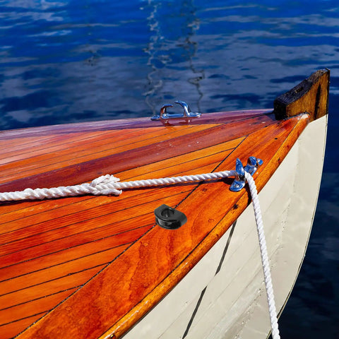 Boat with wooden deck on water featuring heavy duty nylon pulley guide set for boats and kayaks with rolling bearing visible.
