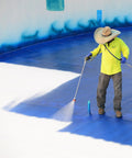 Worker applying Maximum Stretch Waterproof Sealant Membrane for roofing, repairs, concrete, EPDM and wood, DIY friendly, white, USA.