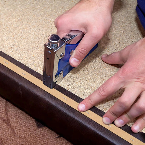 Professional Grade Upholstery Tack Strip Half Inch Wide By Seventy Yards Long Delivers Dead Nuts Straight Edges Hides Staples Quick On Couches Chairs And Recliners No Sweat being stapled onto a leather surface.