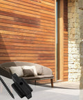 Straight Up Durable Black Nylon Hidden Deck Fasteners Plus T Clips With Heavy Duty Metal Screws For Effortless Composite Board Setup No Fuss Universal Decking Connector Kit 50 Piece next to a brown couch on a wooden deck.