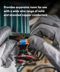 Gloved hands using Two In One Twist On Wire Connector Set 22-12 AWG Orange Blue for secure pigtail connections.