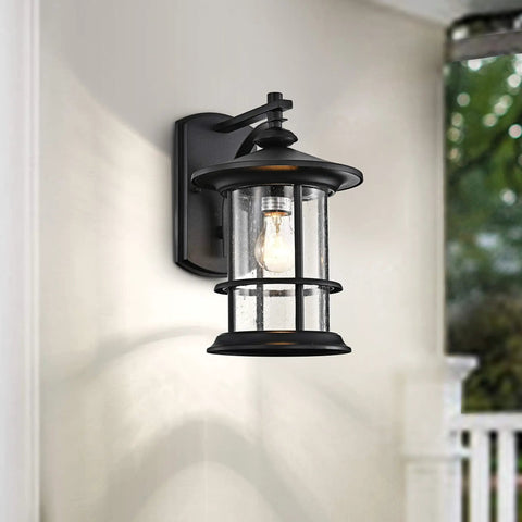 Massive 12.5 Inch Outdoor Wall Light Fixture With Textured Black Finish And Clear Seeded Glass Shade on Porch
