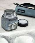Open jar of Cretacolor graphite powder with lid, pouch, and drawing. Focus on smooth smudging and blending, water soluble option. Highly pigmented.