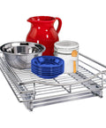 Knockout Kitchen Pull Out Cabinet Organizer with Heavy Duty Commercial Glide System holding red pitcher, stainless bowl, blue plates.