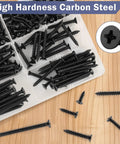 Premium Black Wood Screws Assortment Kit 250 Piece Heavy Duty Carbon Steel Fasteners arranged in a container on wood surface.