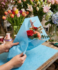 Florist wrapping bouquet with Waterproof Bouquet Wrapping Paper 266 Sheets With Easy Pullout Tissue For Flowers And Florist Arrangements.