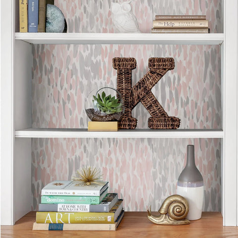 Peel And Stick Pink And Grey Speckle Wallpaper For Walls Easy To Apply And Remove Repositionable And Residue Free showcased on bookshelf