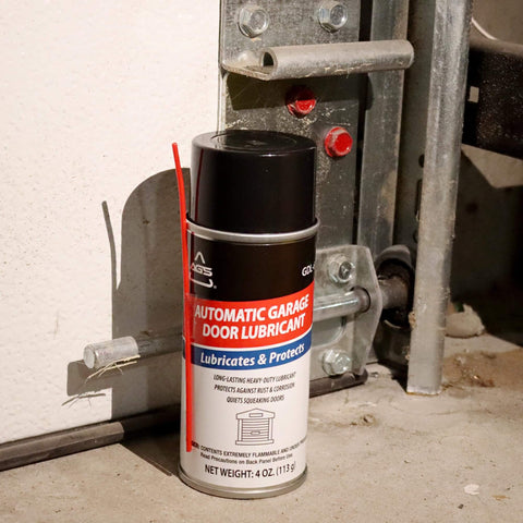 4 oz aerosol can of garage door lubricant spray next to garage track, designed for smooth operation and reducing squeaks.