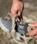 Tracker Knife Outdoor Fixed Blade Bushcraft Camp Knife cutting rope with G10 grip, showing full tang construction in use.